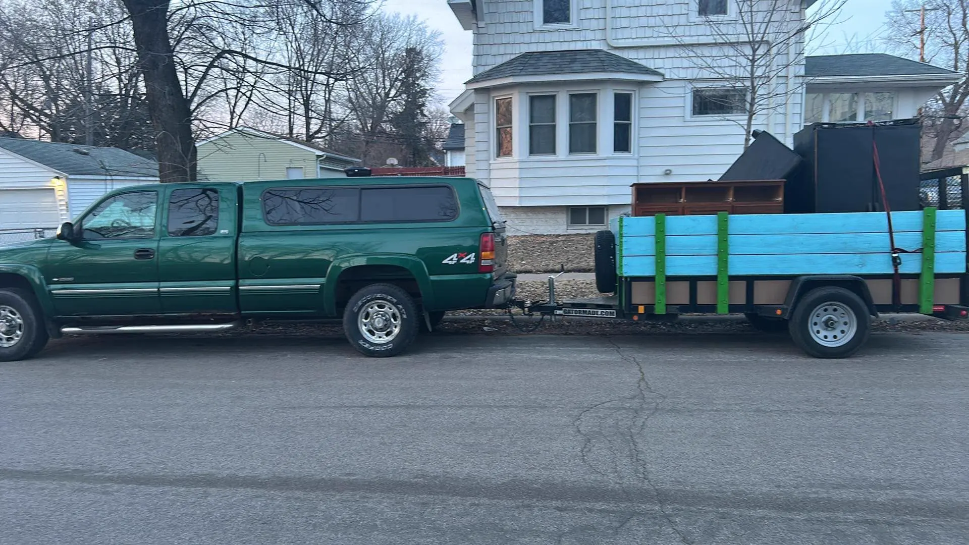 MGM hauling truck and loaded trailer at a residential pickup