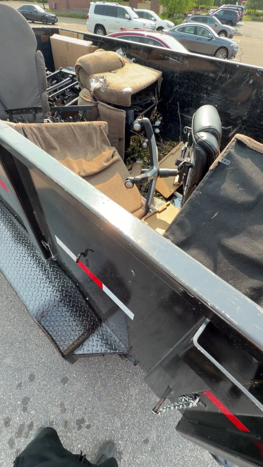 Furniture and chairs loaded into the new black MGM dump trailer