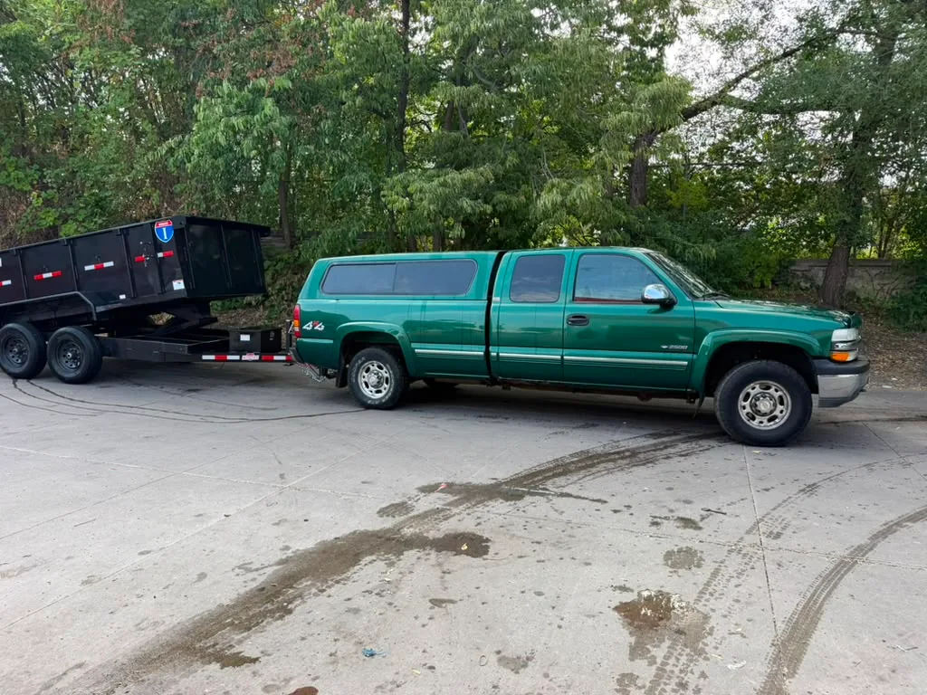 Green MGM hauling pickup with the new black dump trailer